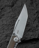 Bestech Togatta BT2102D green canvas micarta inlay detail – layered micarta texture in titanium frame