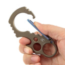 Hand holding Kansept titanium carabiner with green lock and bottle opener