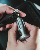 EDC titanium bit driver being used for camping or outdoor repairs