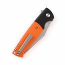Black and orange folding knife with clip point blade and textured handle