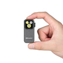 Olight Oclip Pro Phantom Squadron held between fingers showing its compact clip-on size