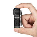 Olight Perun 2 Mini Black held in hand showing its compact size