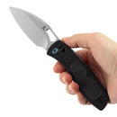 Folding knife with black handle and silver leaf-shaped blade in hand