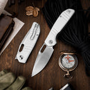 Collection of tactical folding knives with white handles and stainless steel blades